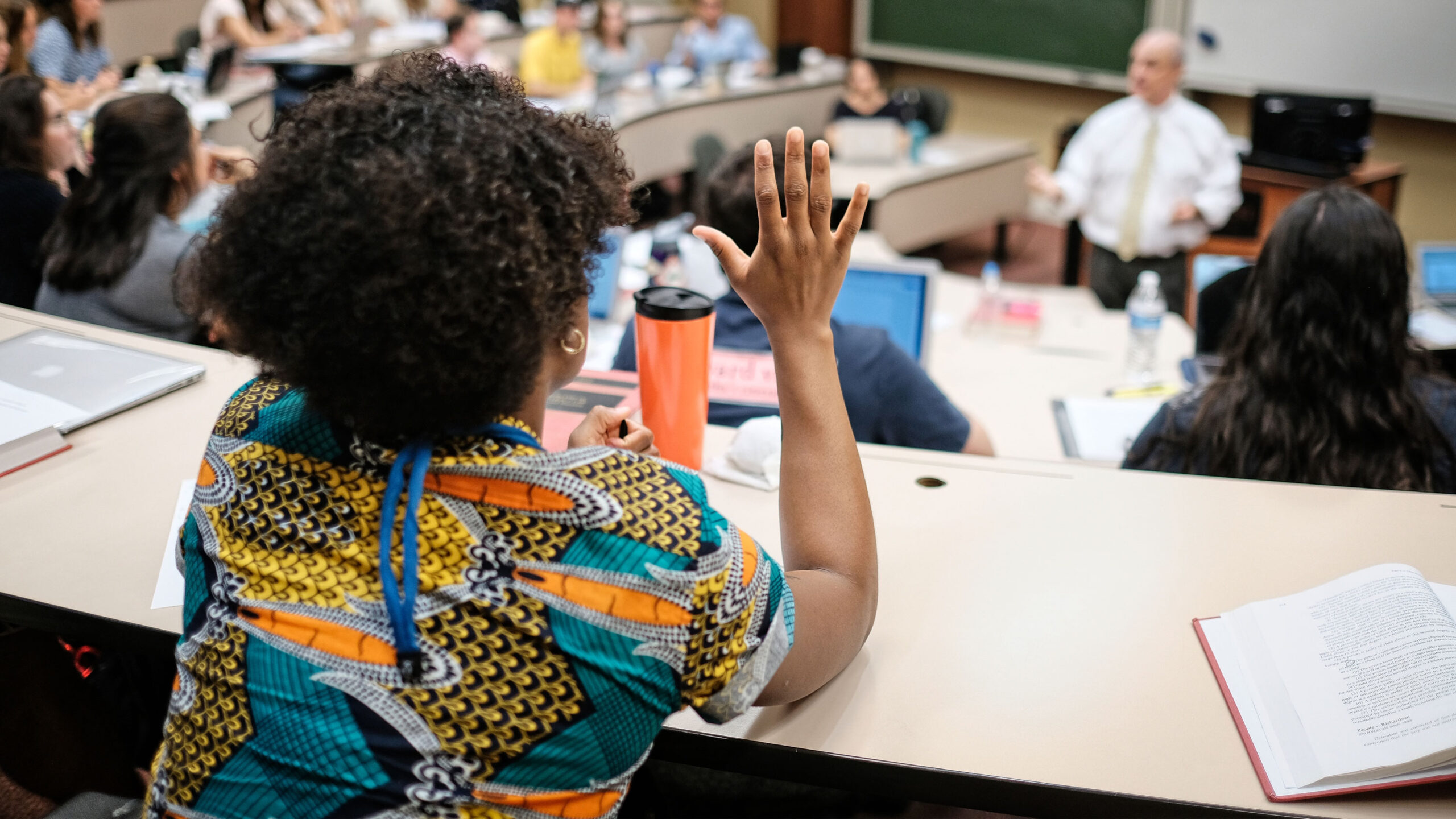 Student raising her hand during class.