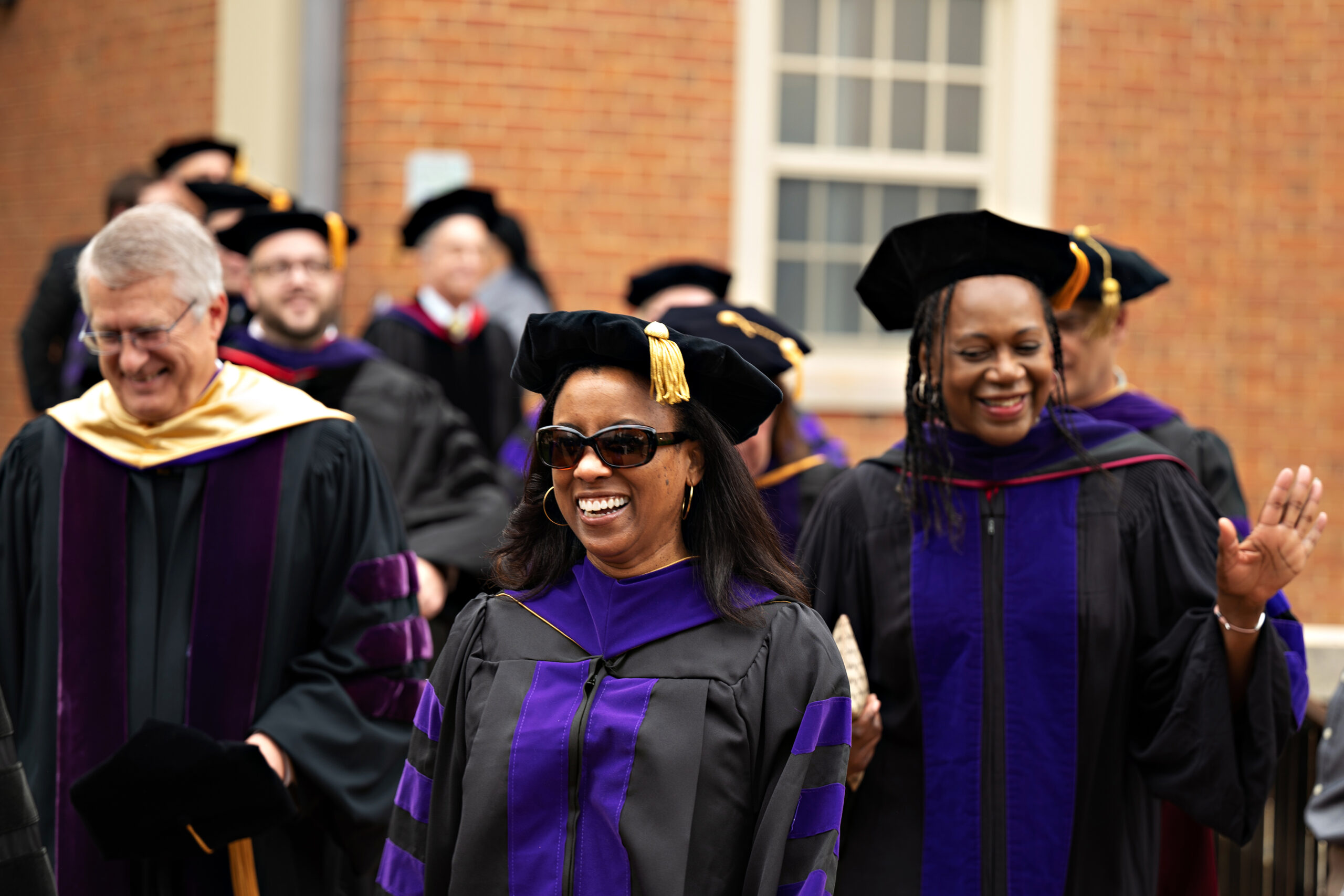 A small group of Wake Forest Law professors in graduation garb during graduation.