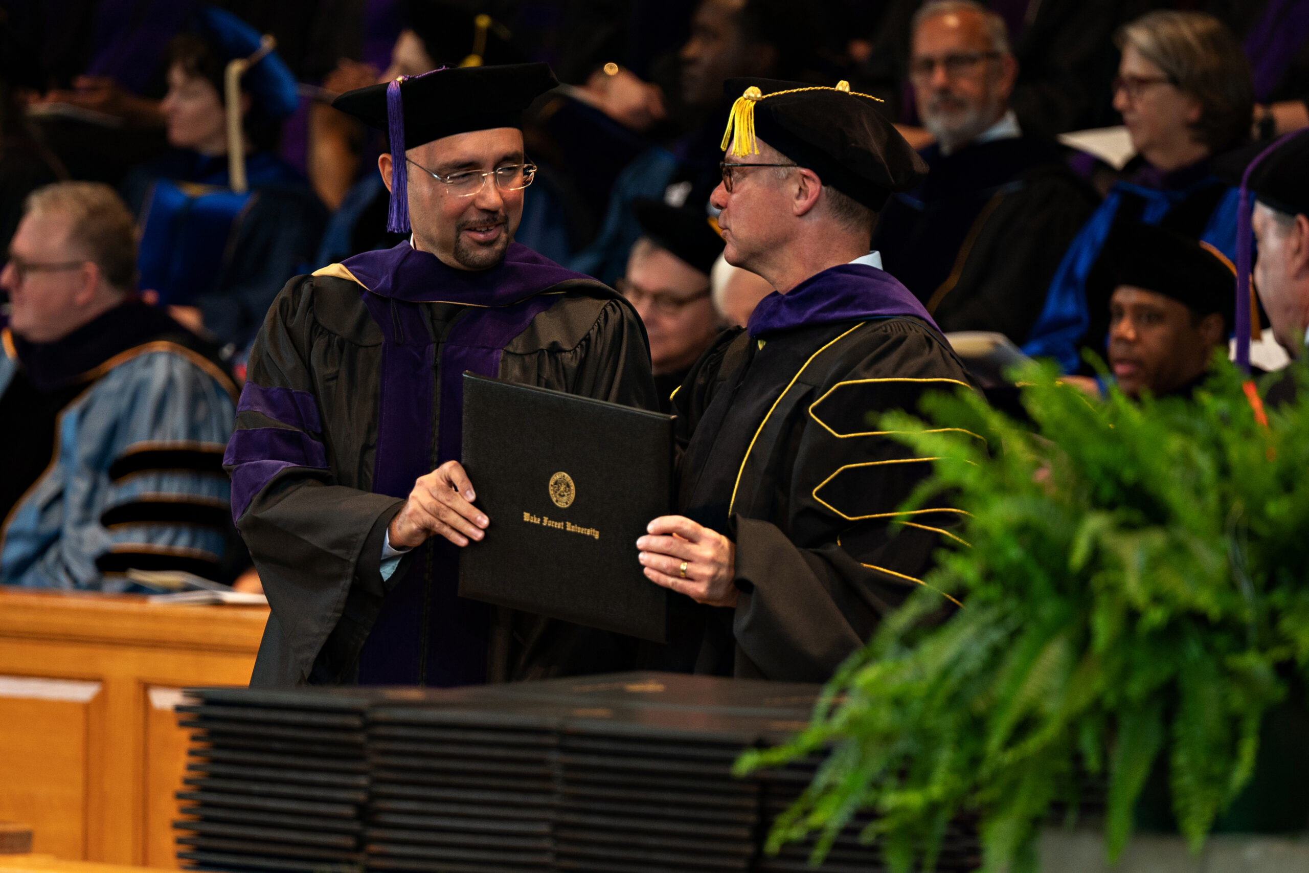 Two Wake Forest Law professors during the hooding ceremony at graduation.