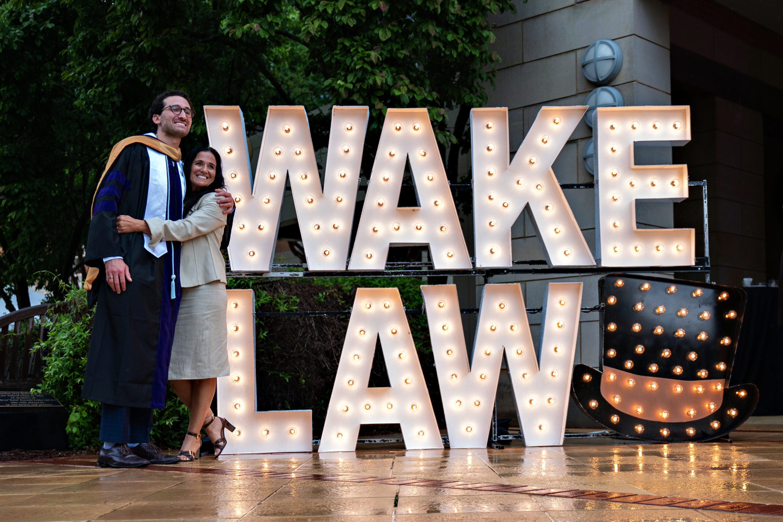 Wake Forest Law grad and another person engage with one another following commencement