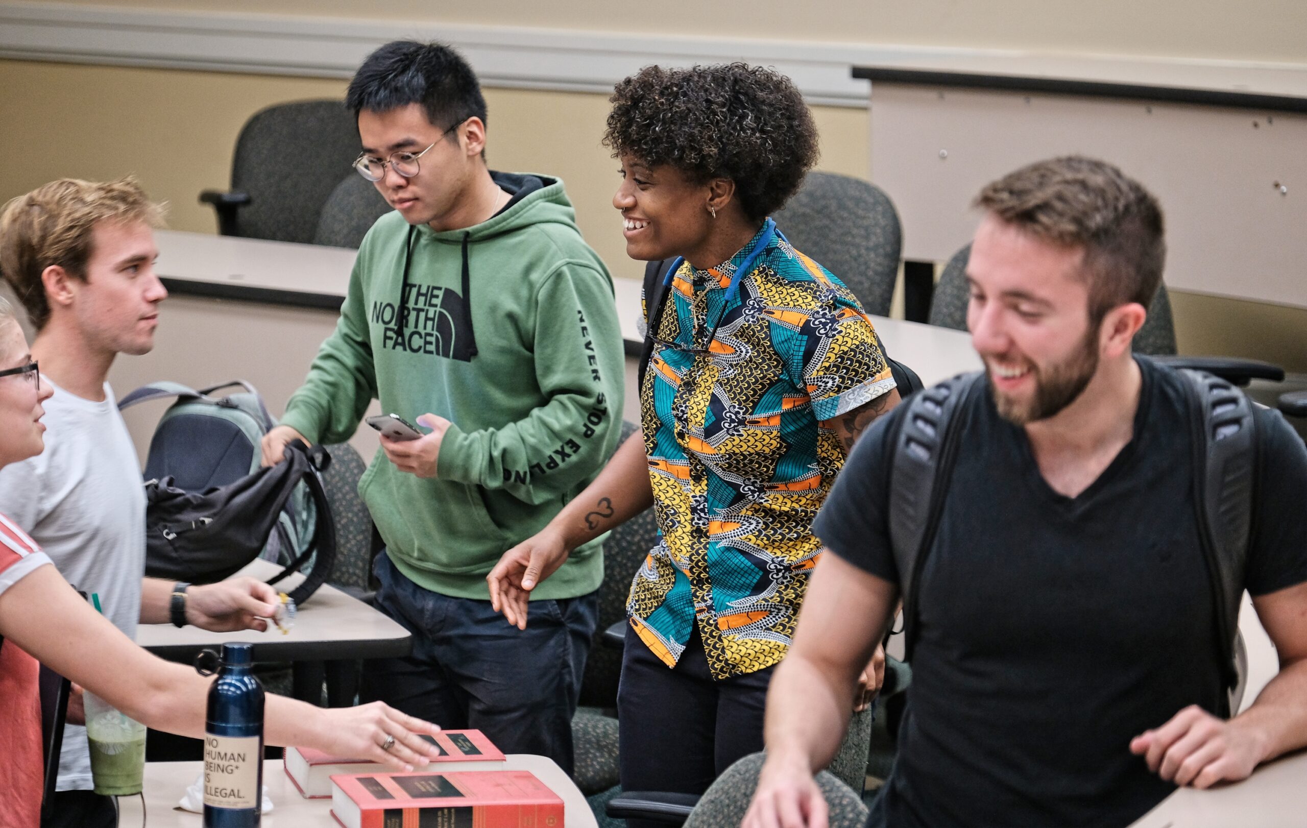 Five students having a conversation after class.