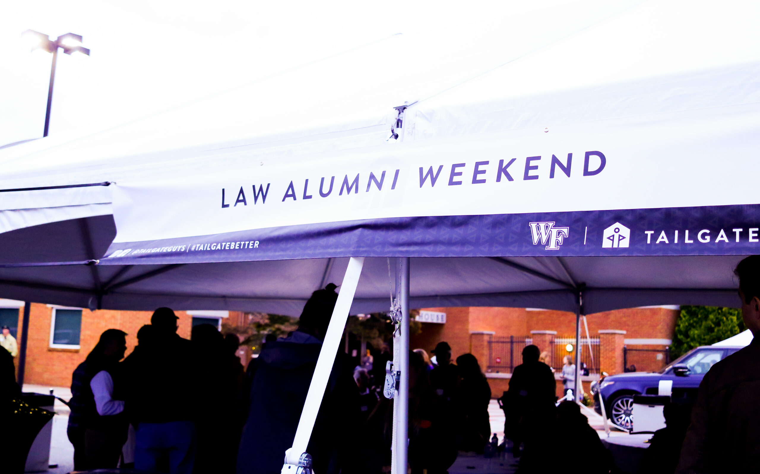 People gathered under a tent during Law Alumni Weekend.