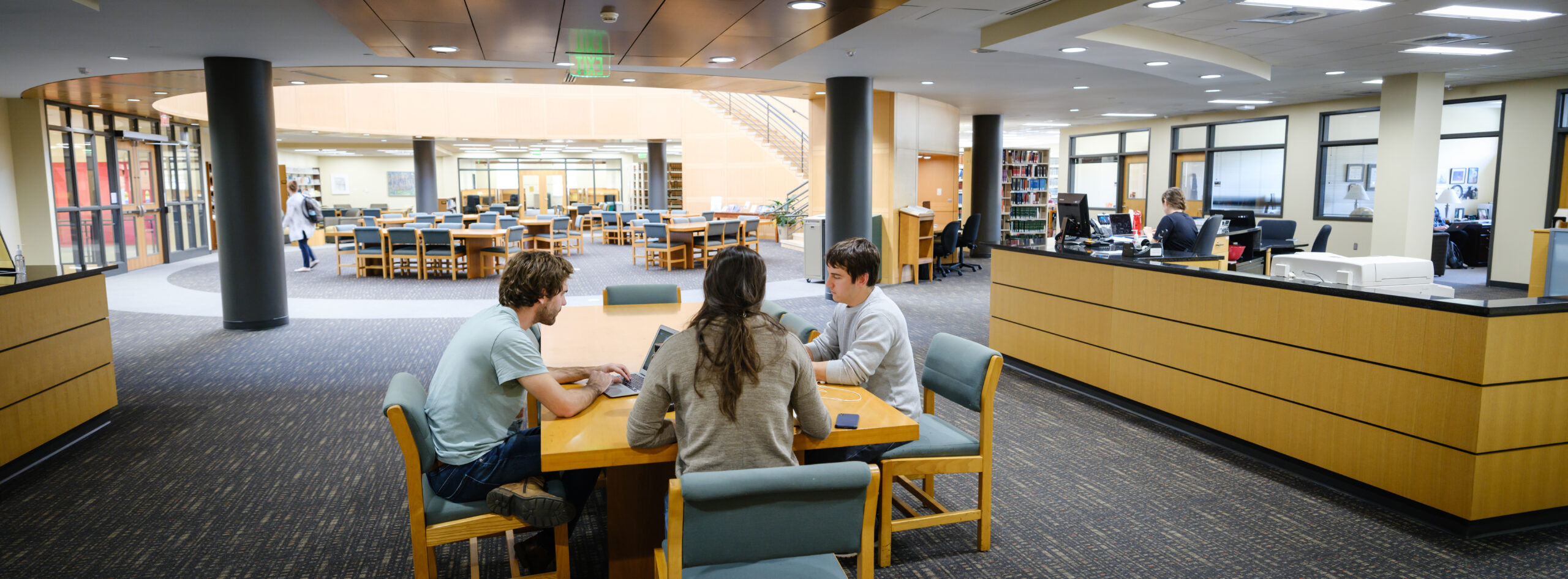 Three students studying together at a table in the Wake Forest library.