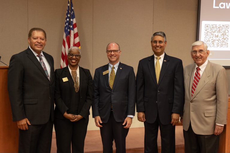 Dean Klein posing for a picture with four other adults in formal wear.