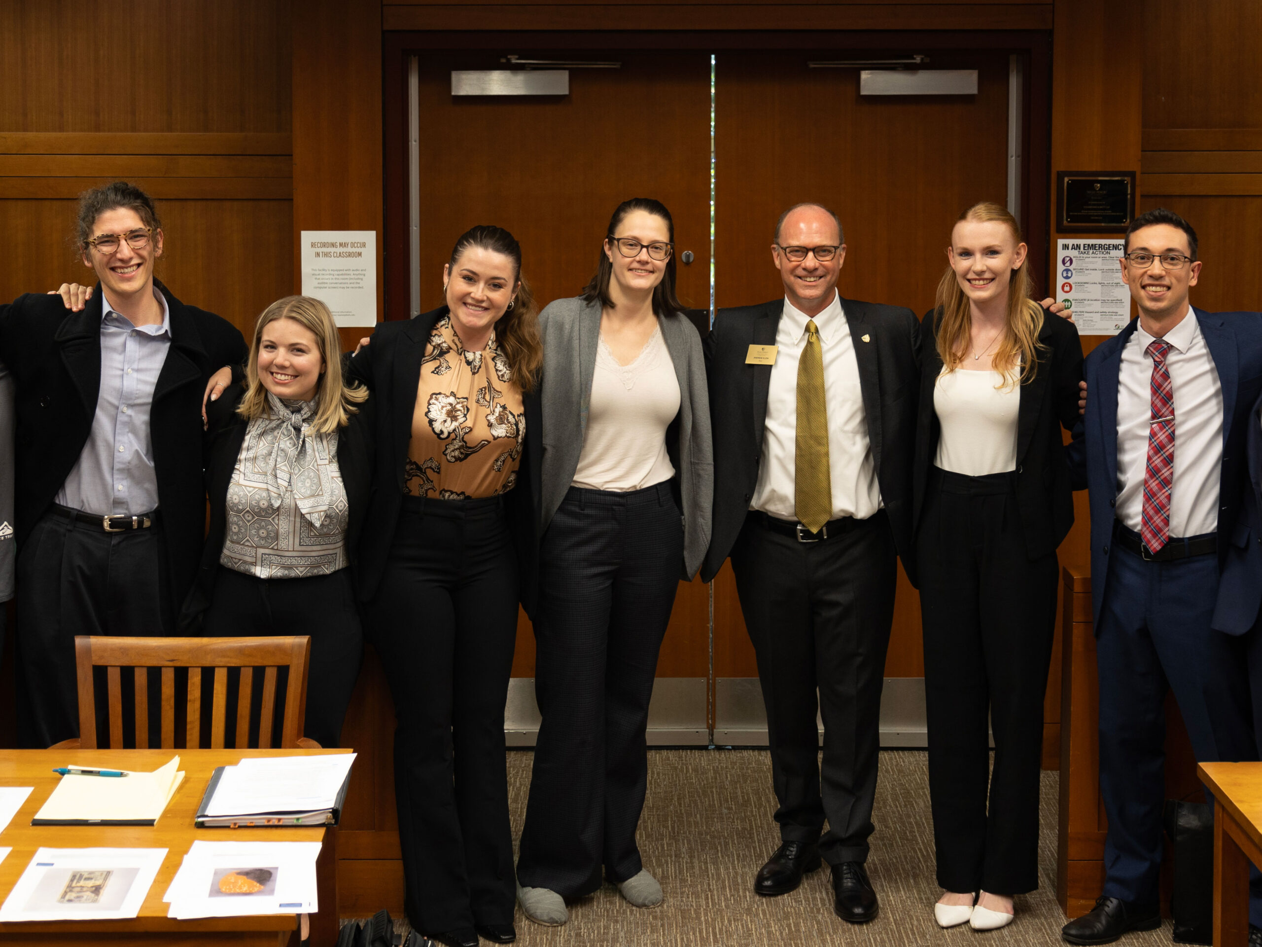 Six Wake Forest Law students posing with a Wake Forest representative at trial practice.