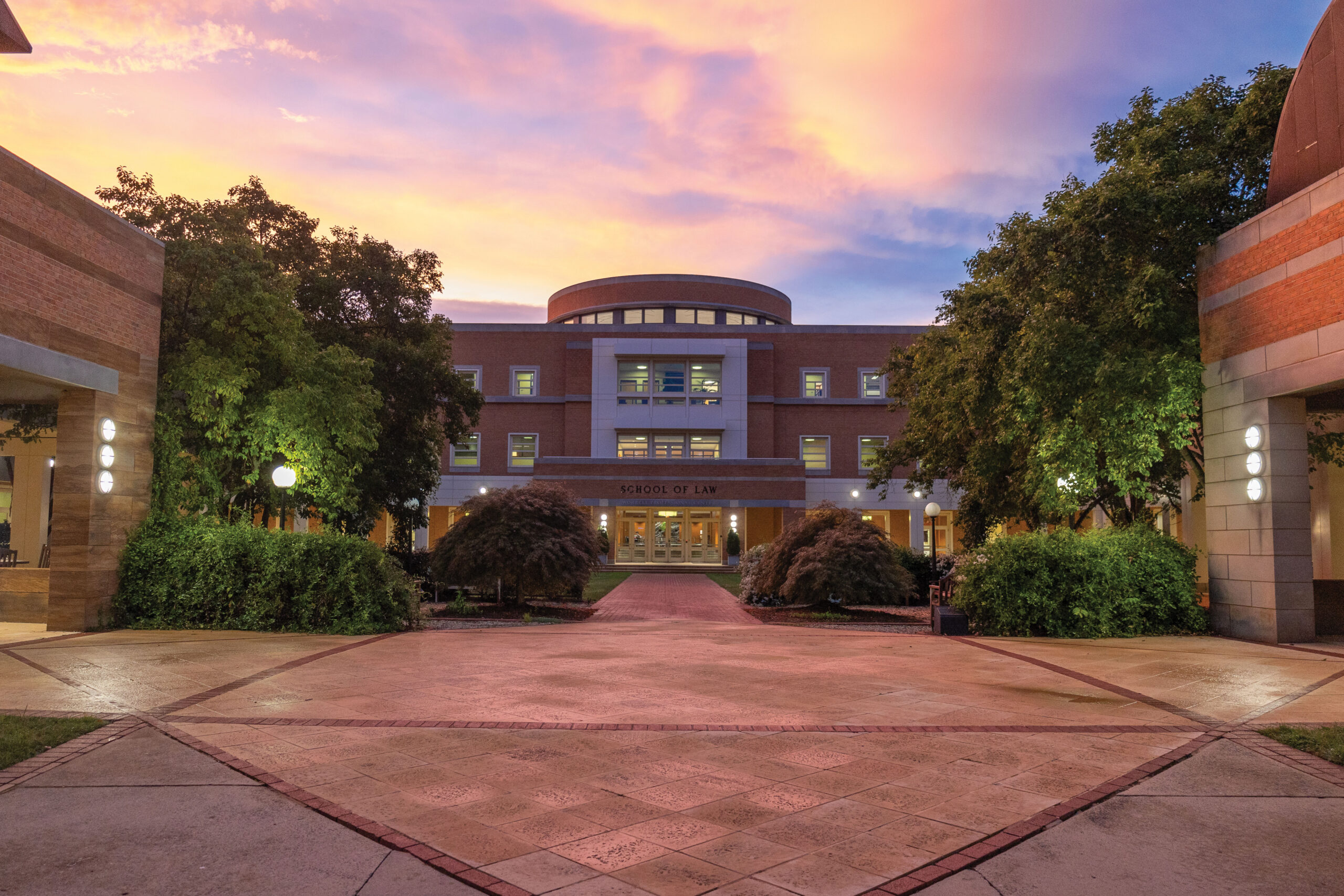 Worrell Professional Center Building, home to Wake Forest Law, with a blue partly cloudy sky in the background.