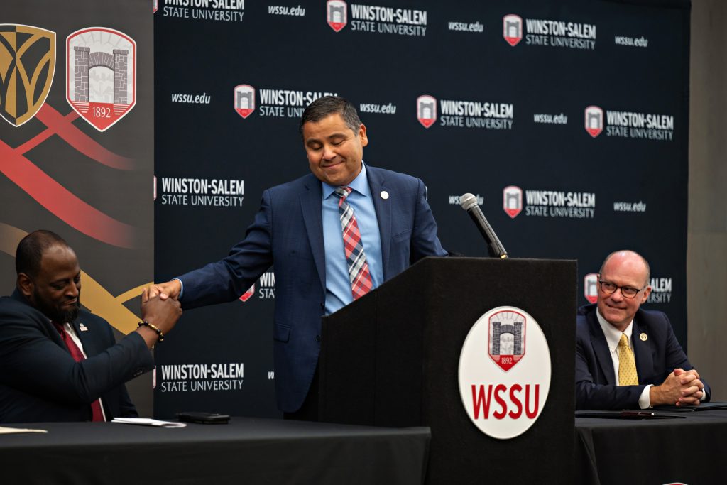 Wake Forest Chief Diversity Office Jose Villalba shakes hand of WSSU Provost Anthony Graham