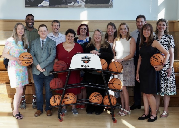 Legal Writing Institute members (men and women) posing with basketballs