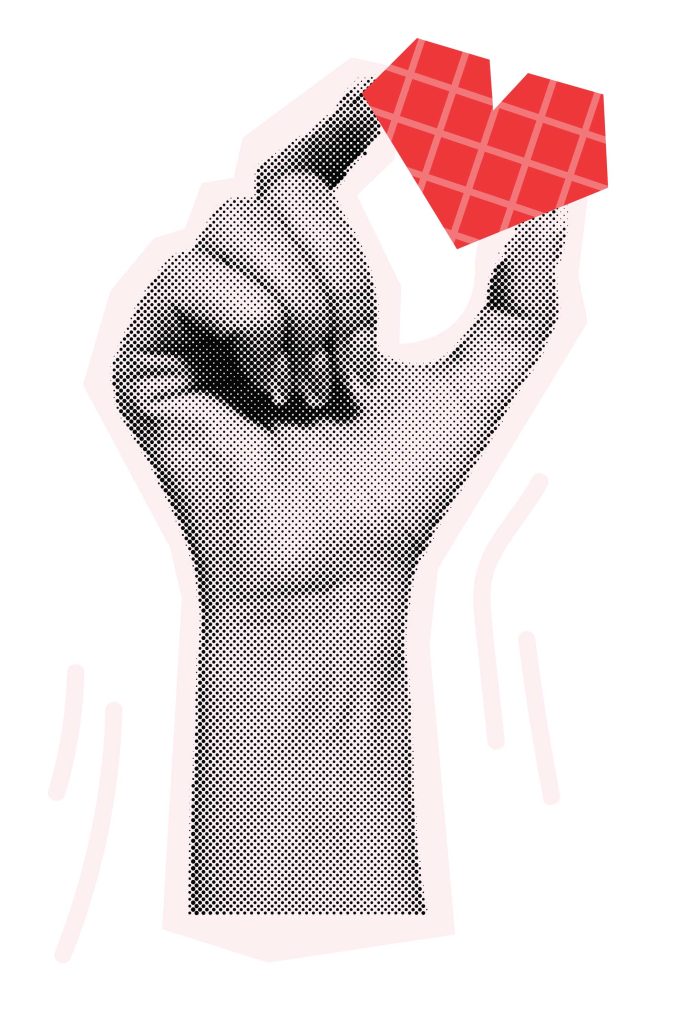 hand holding a paper cut out of a red heart