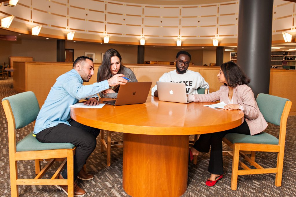 students working together at a table in the library
