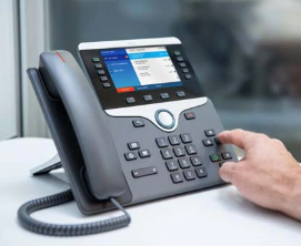 Cisco phone with hand pushing a button