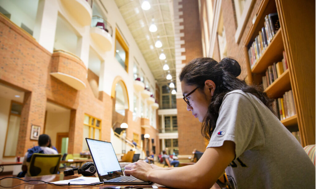 female student working on her laptop