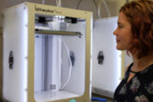 female student watching a 3d printer