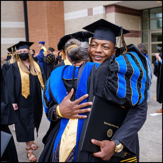 graduate students hugging