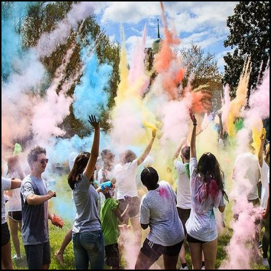 people celebrating with colored smoke