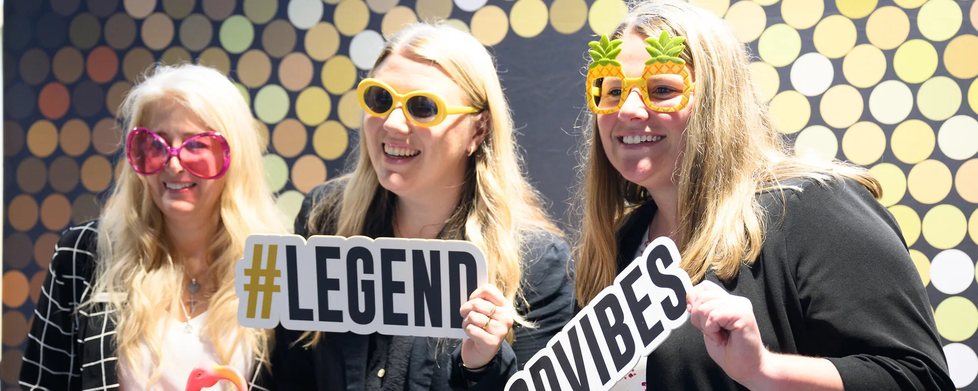 Wake Forest University faculty and staff attend the University-wide Staff Appreciation Event at the Sutton Center on Wednesday, June 7, 2023. Staff hold up signs for LEGEND and GOOD VIBES