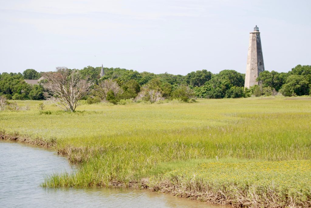 Old Baldy Lighthouse in the background of untouched coastal island