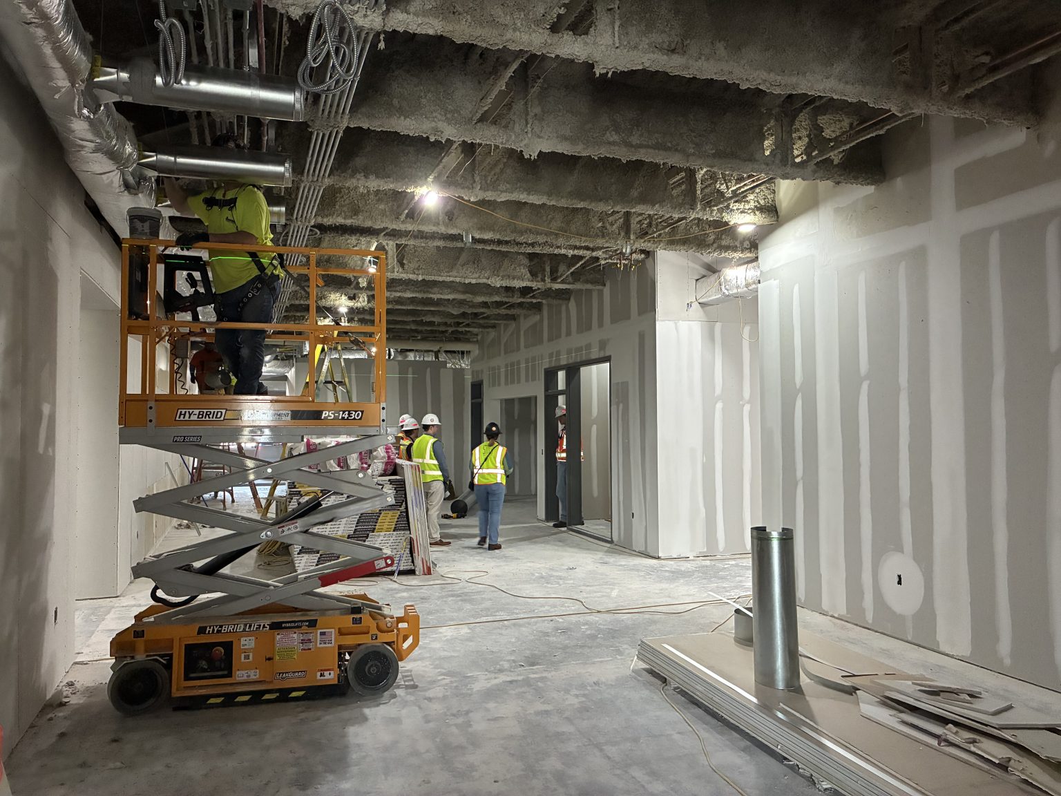 Forklift and workers during the Alumni Hall renovation