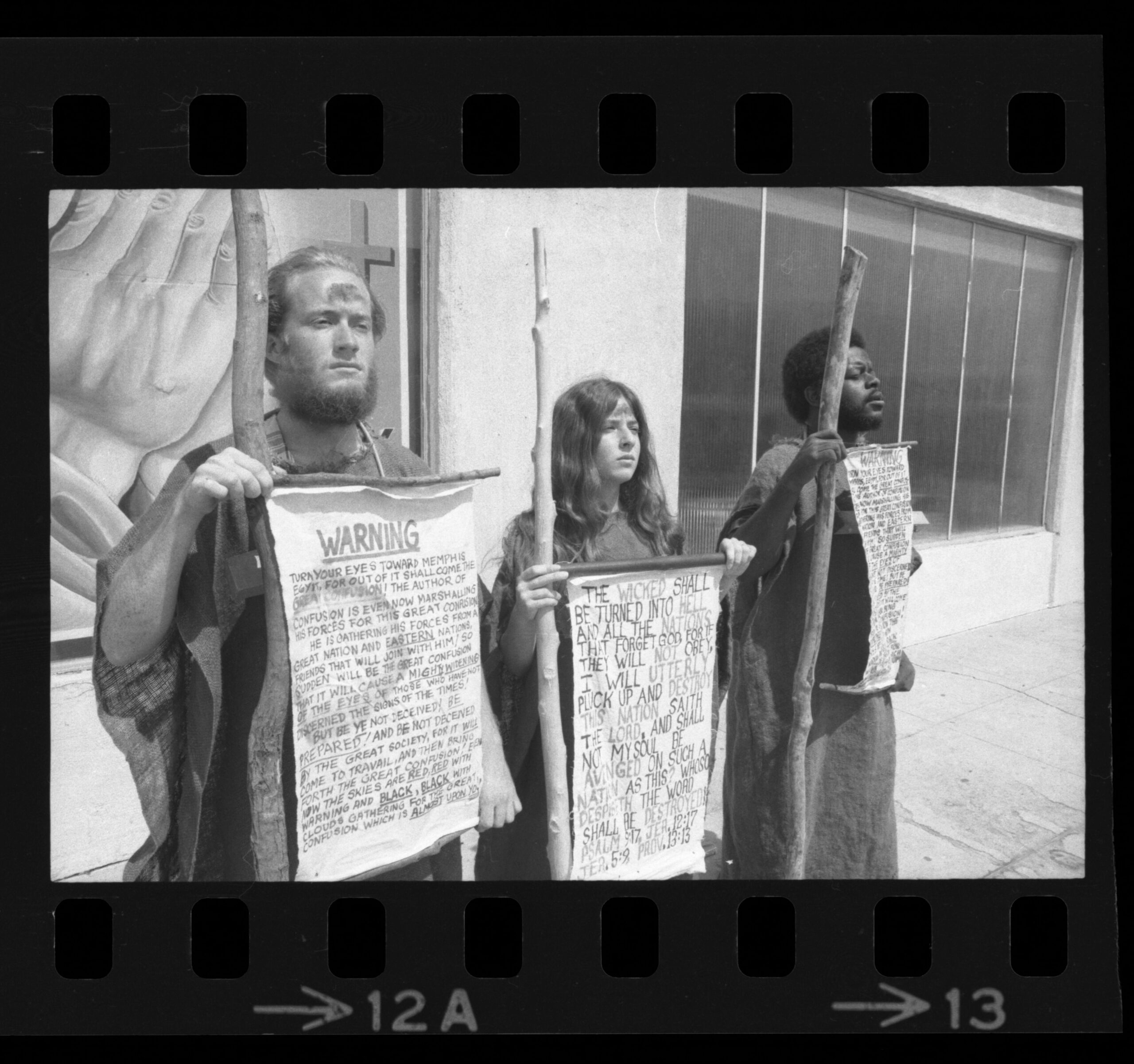 Figure 1: Sackcloth Vigil Participants with scrolls featuring biblical verses warning Americans to repent.
