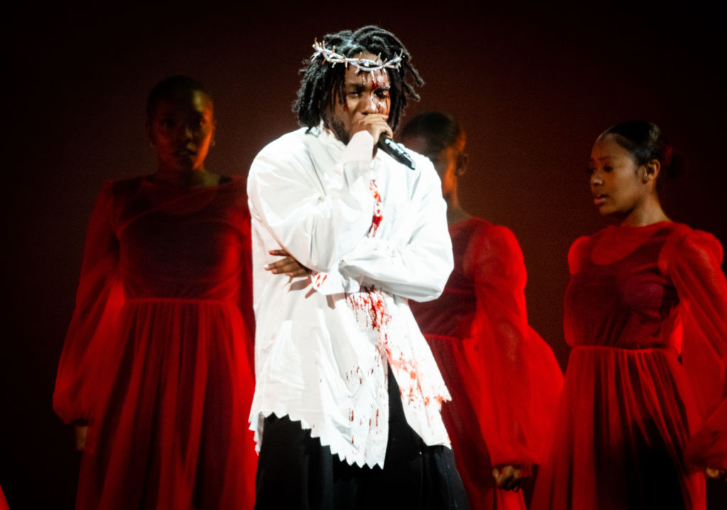 Figure 2: Kendrick Lamar on stage wearing a crown of thorns--fake blood spills down his face onto his white shirt.