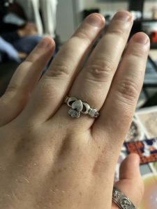 Figure 5: Woman wearing silver Claddagh ring on middle finger of left hand.