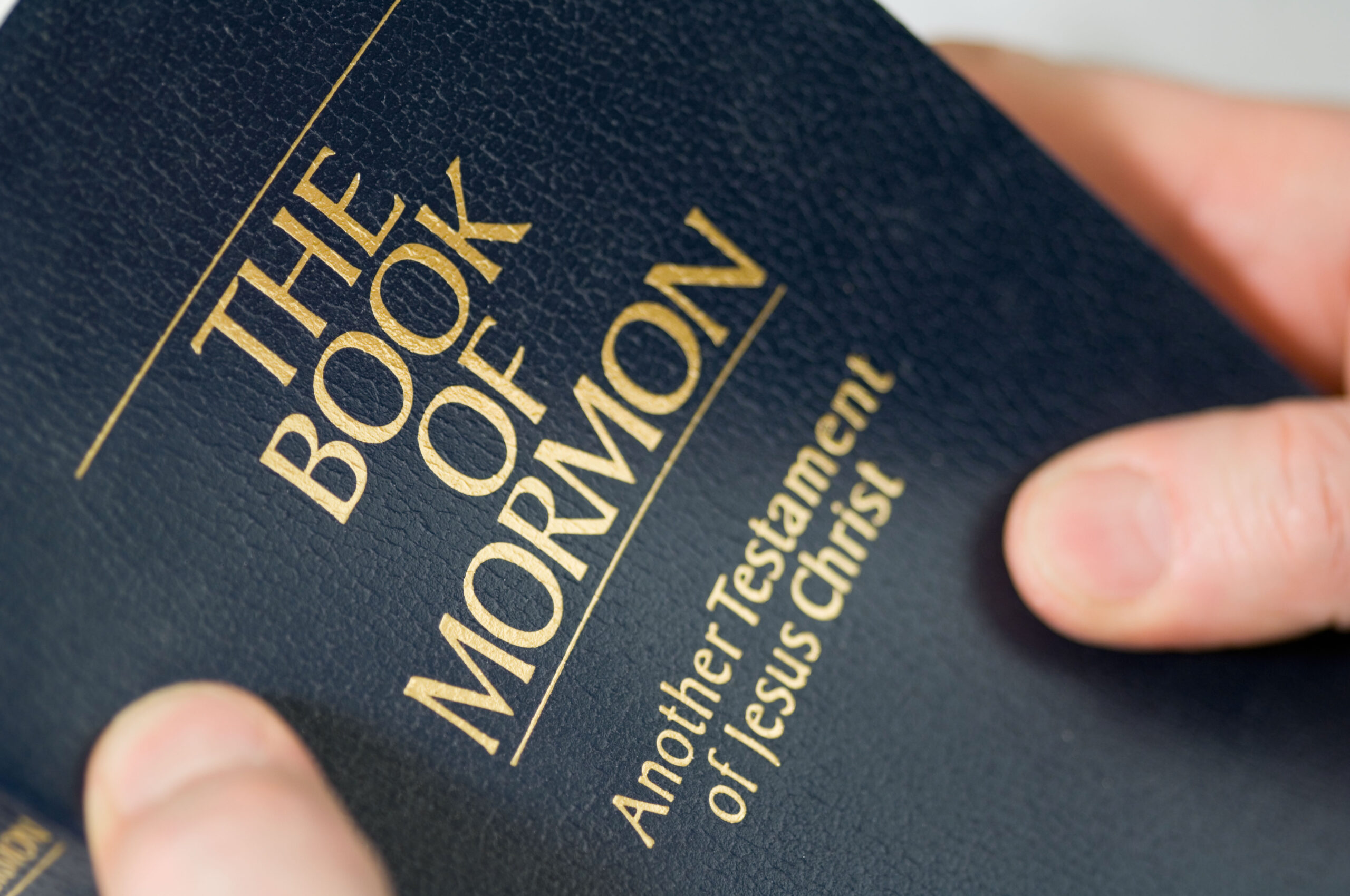 Photo of someone holding the Book of Mormon.