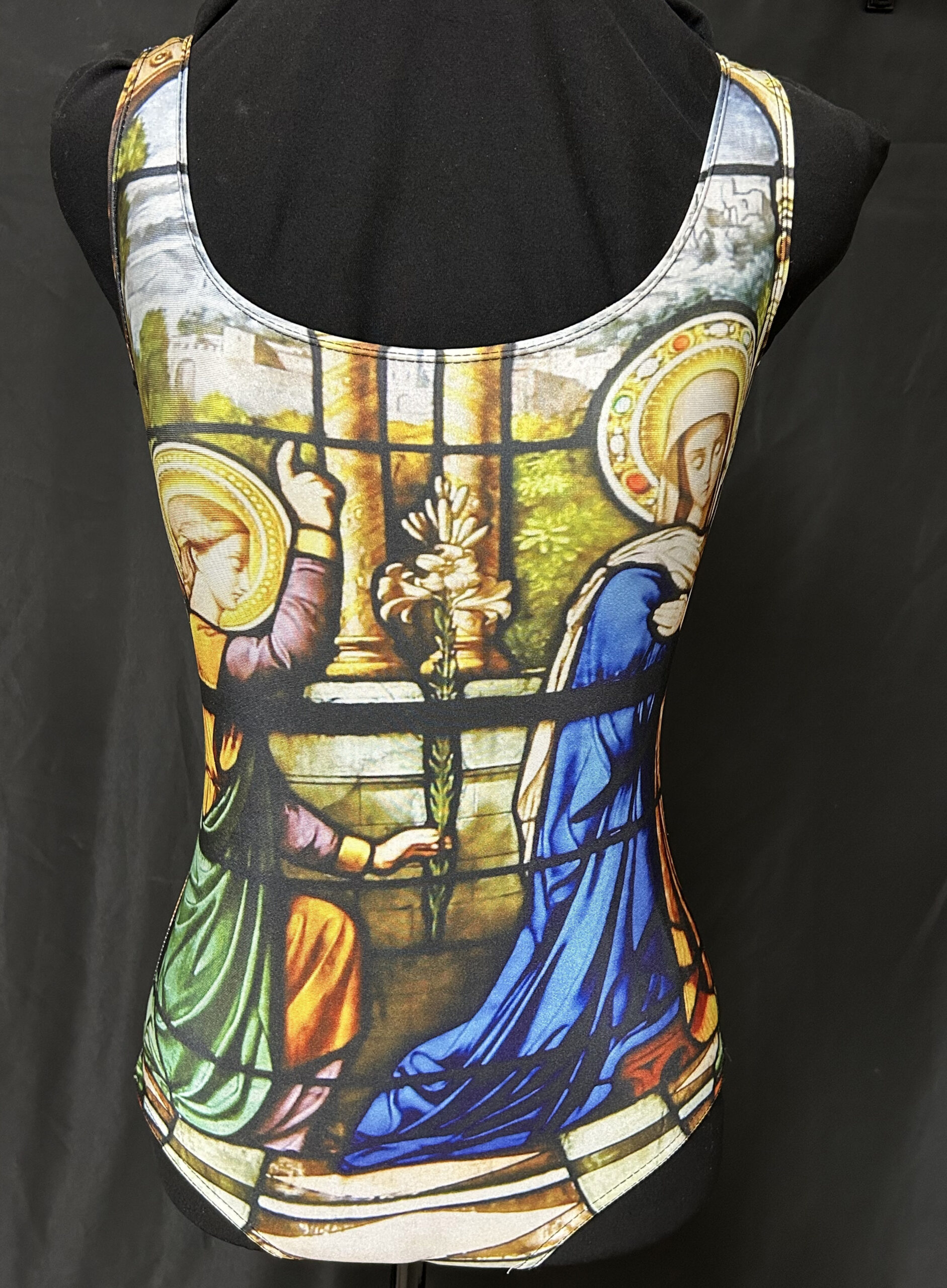 The angel Gabriel appearing to Mary in stained glass appears on the front of the bathing suit. 