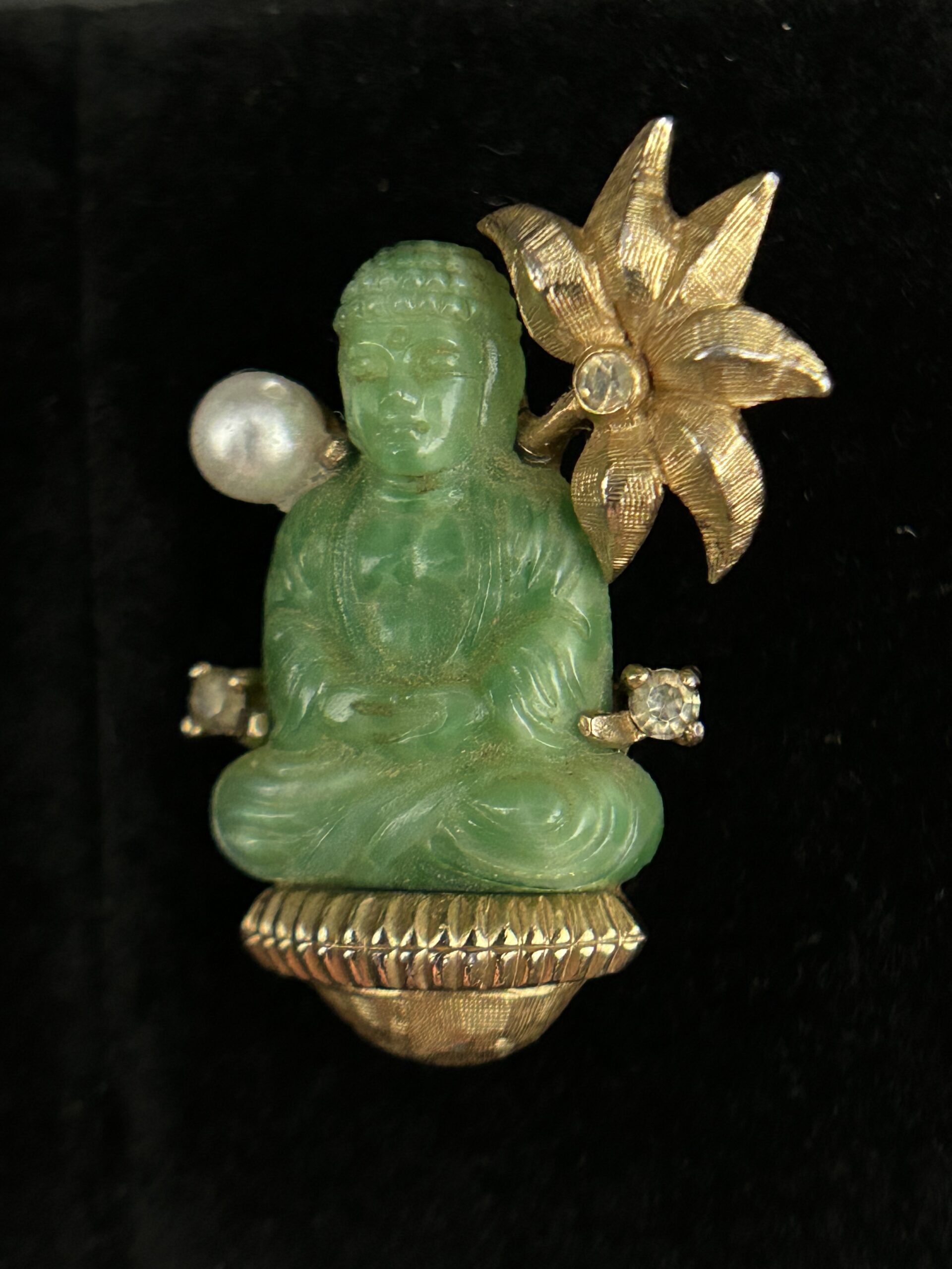 Figure 2: Close-up of J.J. Mazer brooch featuring meditating Buddha and lotus flower that was featured in the 1961 Lord & Taylor advertisement. Photo by author.
