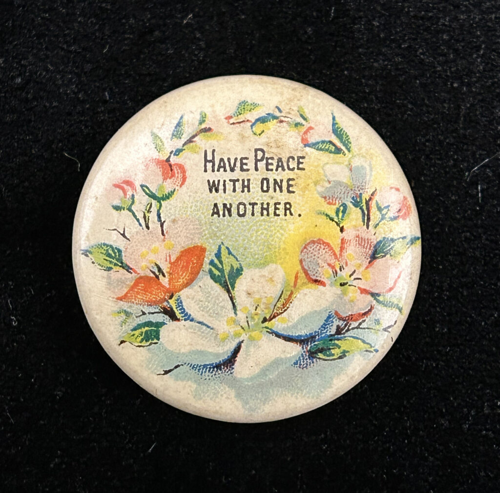 Figure 6: Scriptural pinback button with floral motif made by Whitehead & Hoag for David C. Cook Publishing. Photo by author.