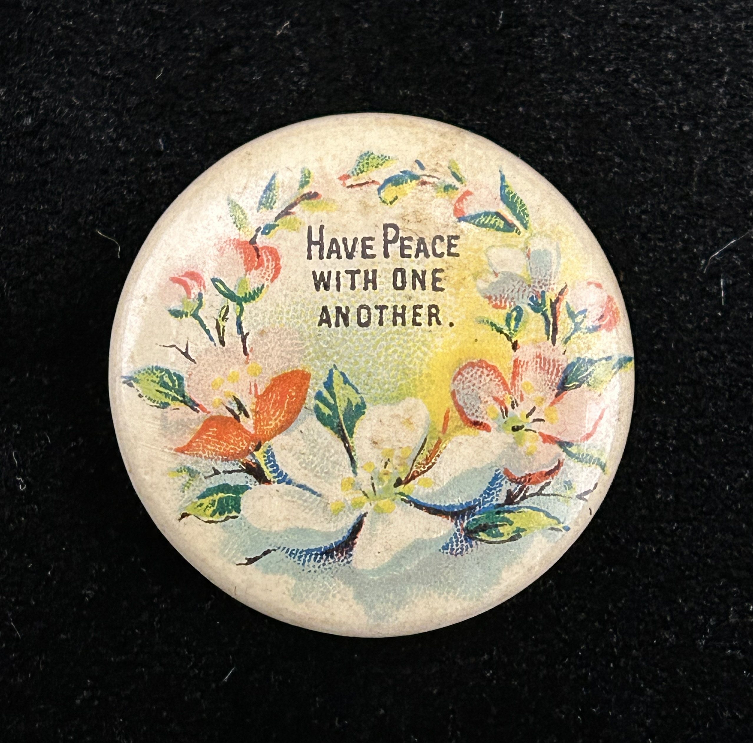 Figure 6: Scriptural pinback button with floral motif made by Whitehead & Hoag for David C. Cook Publishing. Photo by author.