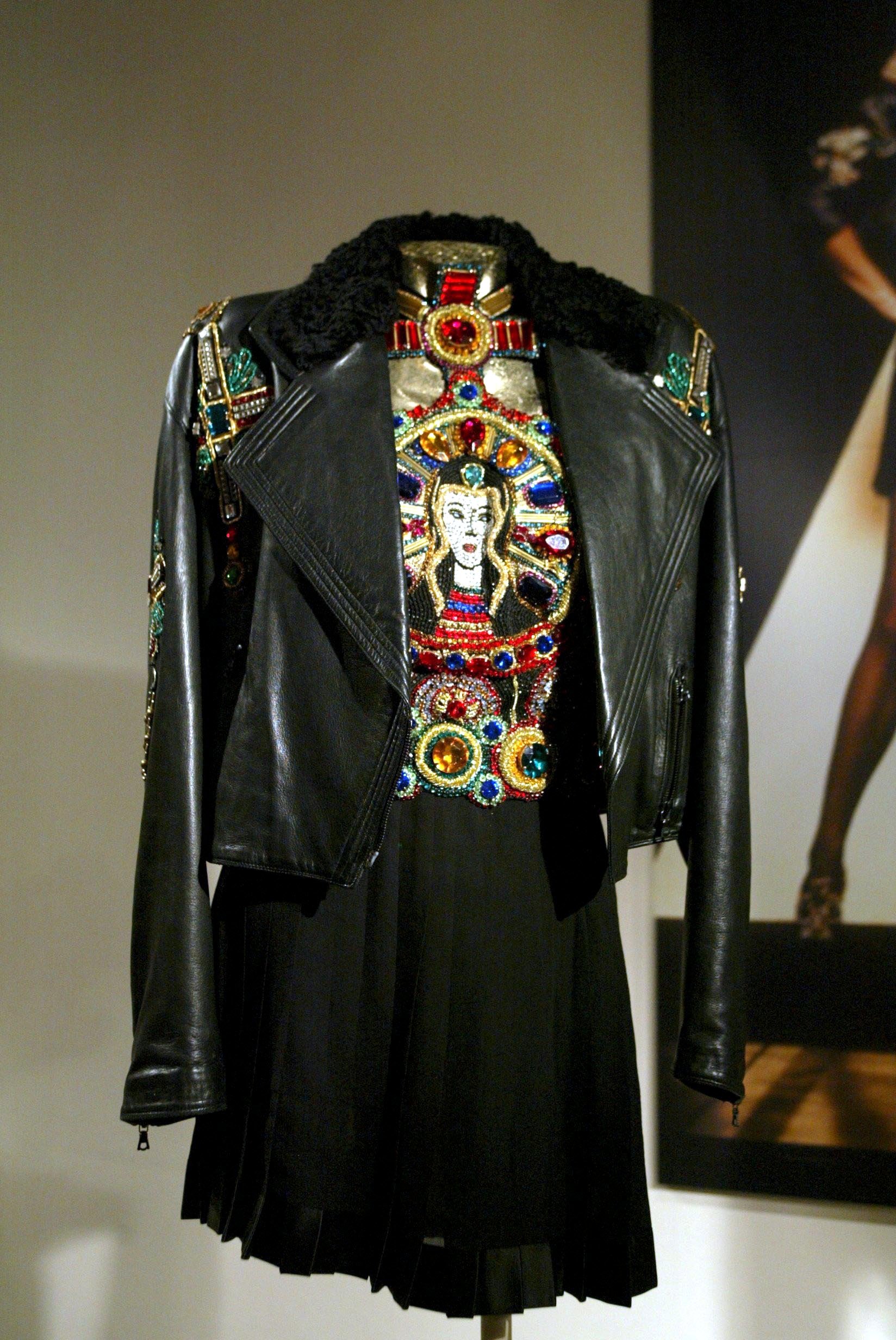 Black biker jacket embellished with crosses and not revealed until the apex of the runway, was a halter top boldly featuring the Virgin Mary