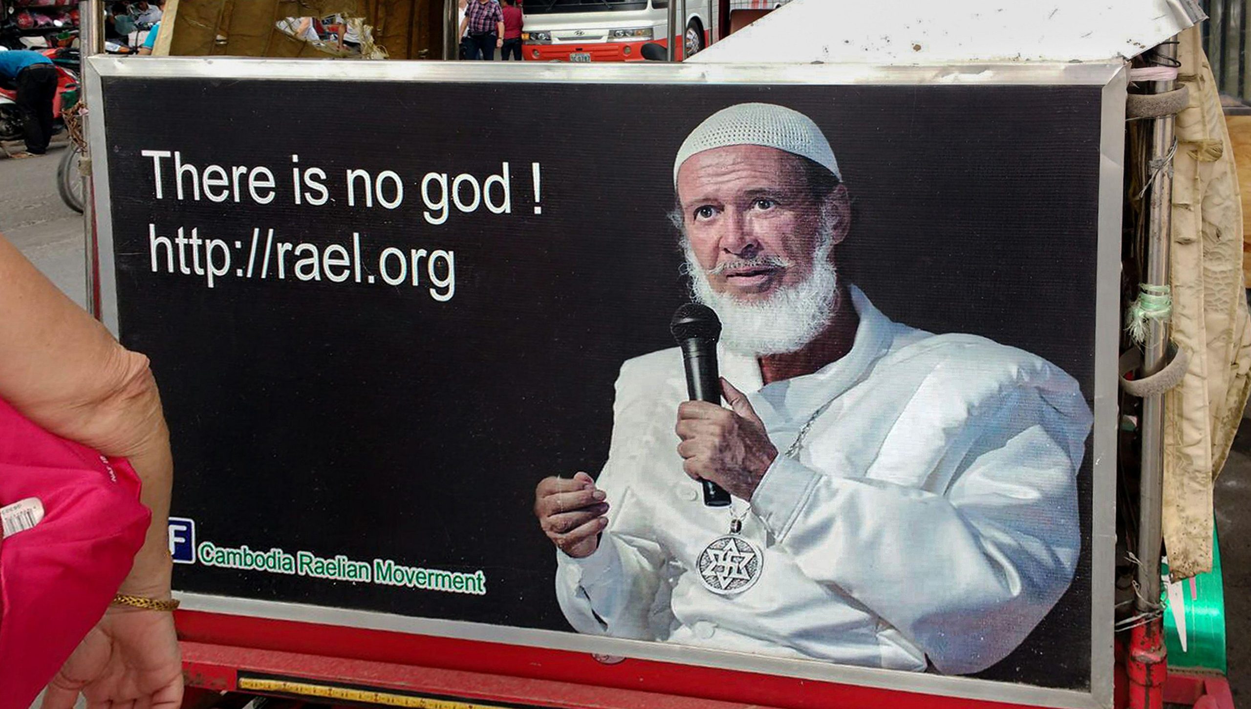 Figure 1: Advertisement featuring Raël wearing the Raelian Medallion along with his distinct white attire. Photograph by Kevin Izorce/Alamy.