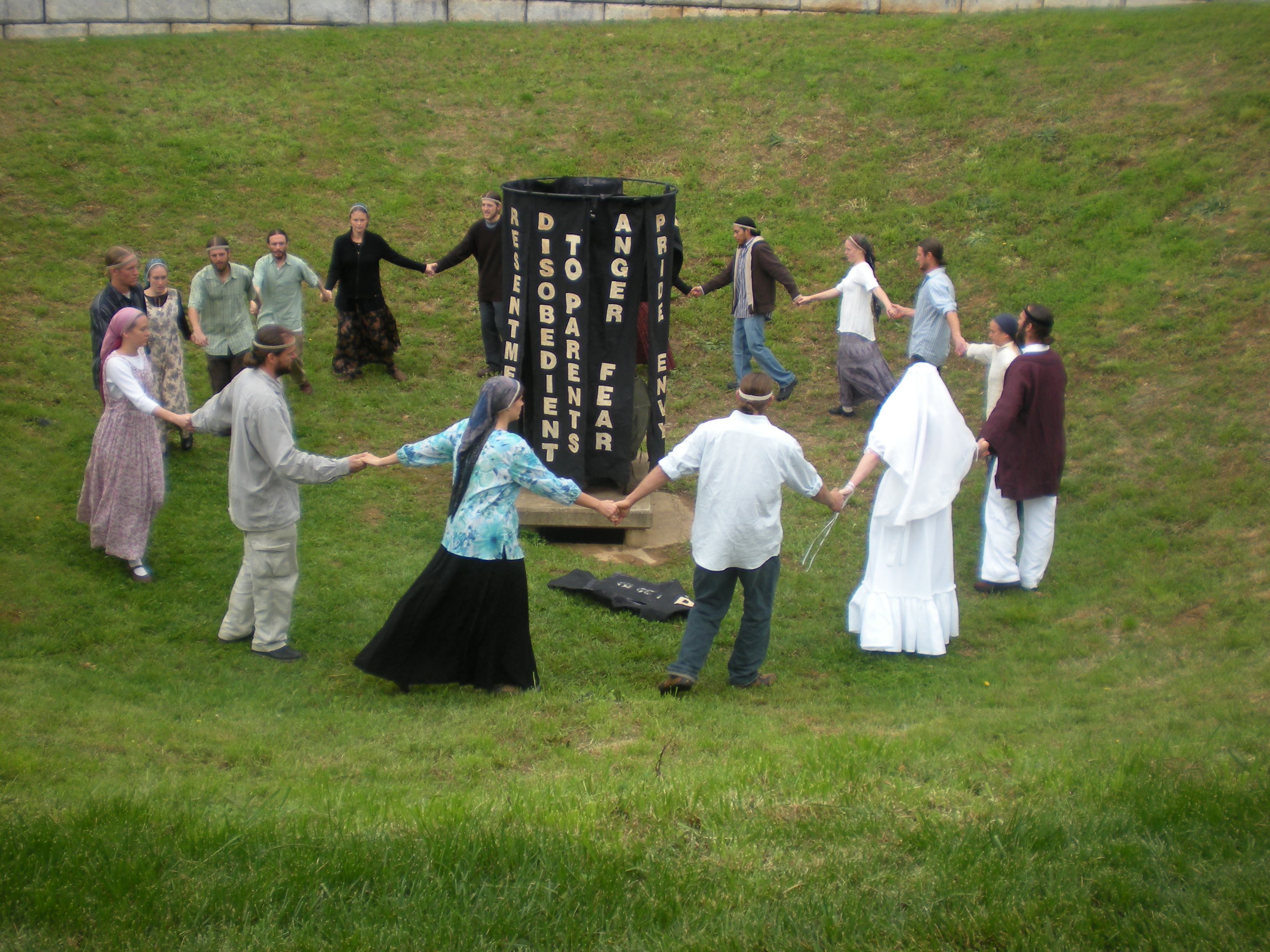 Figure 1: A ceremonial dance performed at a Twelve Tribes wedding. Participants wear distinct clothing and circle a list of sins. Photography by B. Gibson Barkley. CC BY-SA 3.0.