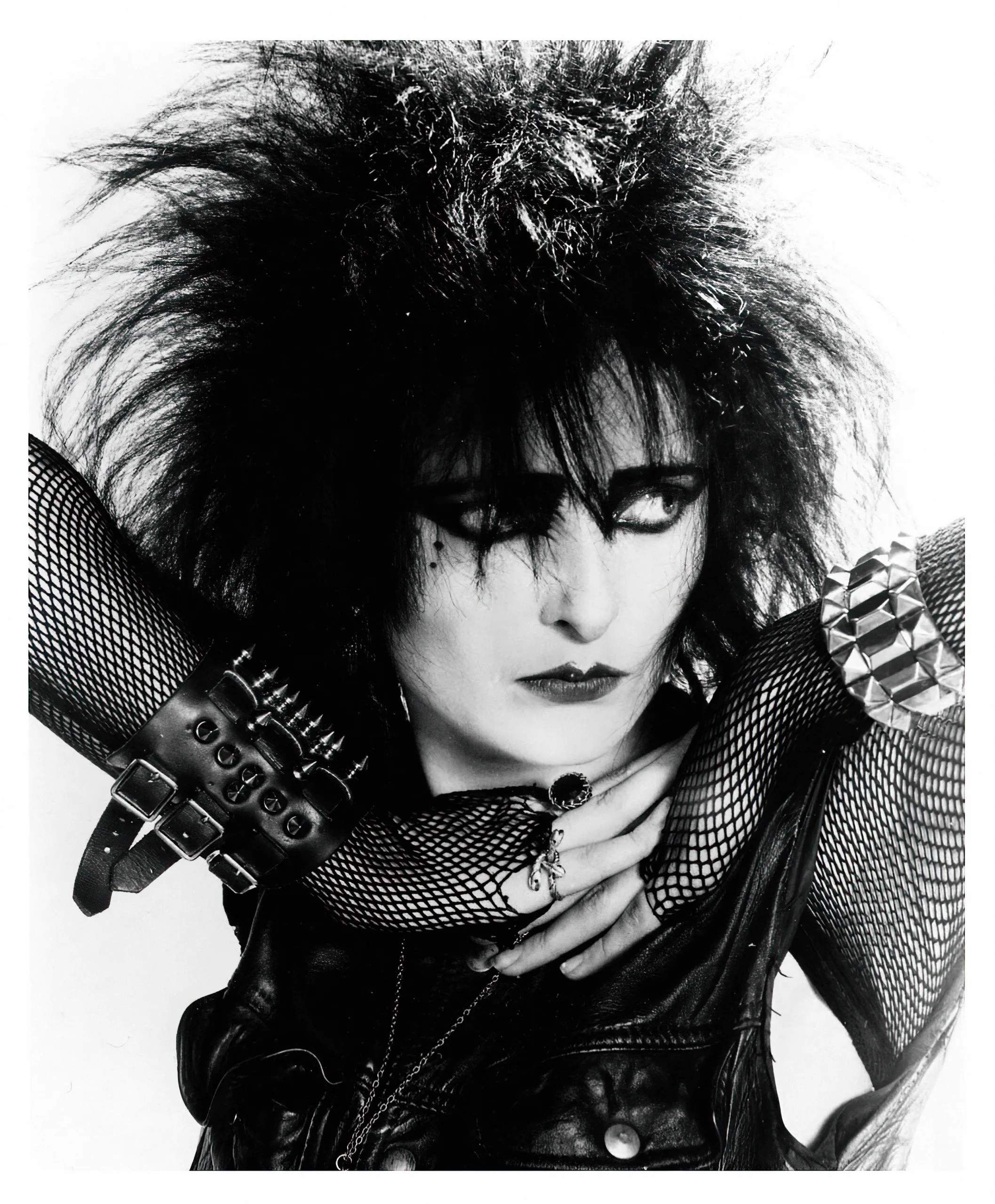 Figure 3: Siouxsie Sioux from Siouxsie and the Banshees was a prominent influence on the emerging Goth style of the 1980s. Dramatic black hair and makeup along with black clothing and numerous accessories helped create some of the fashion characteristics of the movement. Photograph from Alamy. 2X3EGDY Siouxsie Sioux  001 - Vintage music label promotional picture - Photographer unknow, for editorial use only