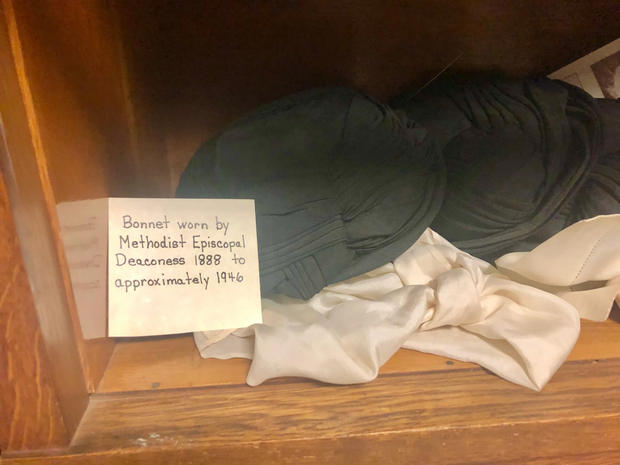 Figure 4: Two historical bonnets displayed at the Brooks-Howell retirement community. Courtesy of Brooks-Howell.