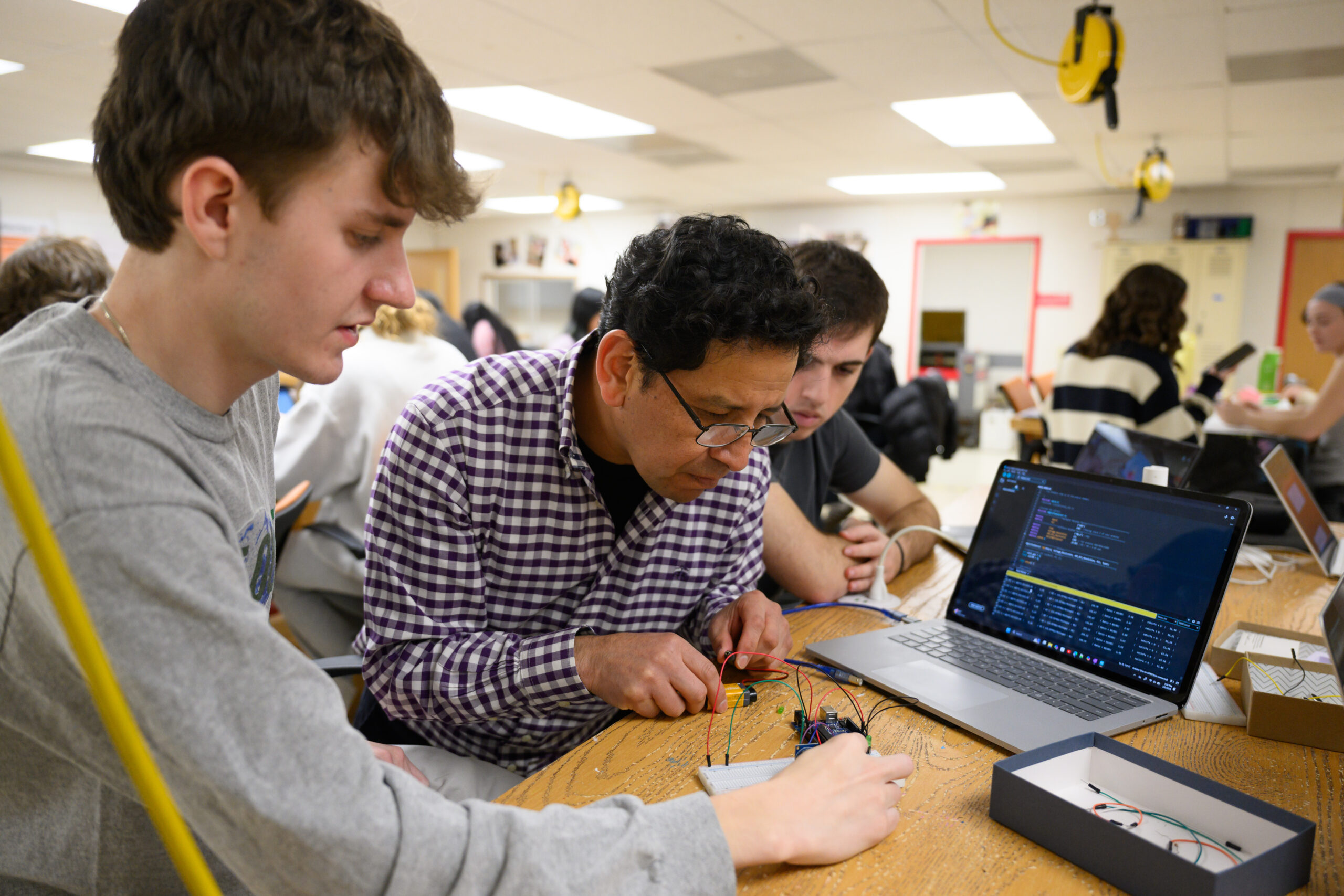 Computer Science Prof. Paúl Pauca teaches a Mobile and Pervasive Computing class at WakerSpace on Thursday, February 6, 2025. Micah Bozkurtian ('25) and Trevor Finnegan ('26), work together in class.