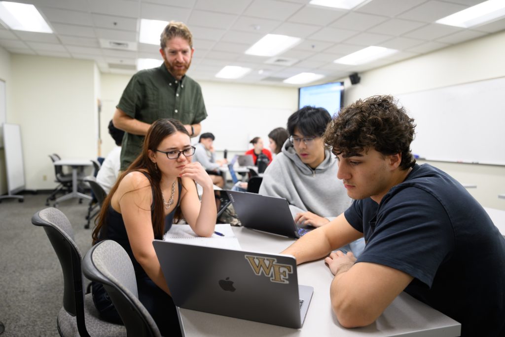 Wake Forest University Prof. Grey Ballard teaches his Numerical Linear Algebra class in Manchester Hall on Wednesday, February 26, 2025. Ruby Flanagan (‘26), Kyle Shepherd (‘26) and Ray Sun (‘25) work through the coding exercise together.