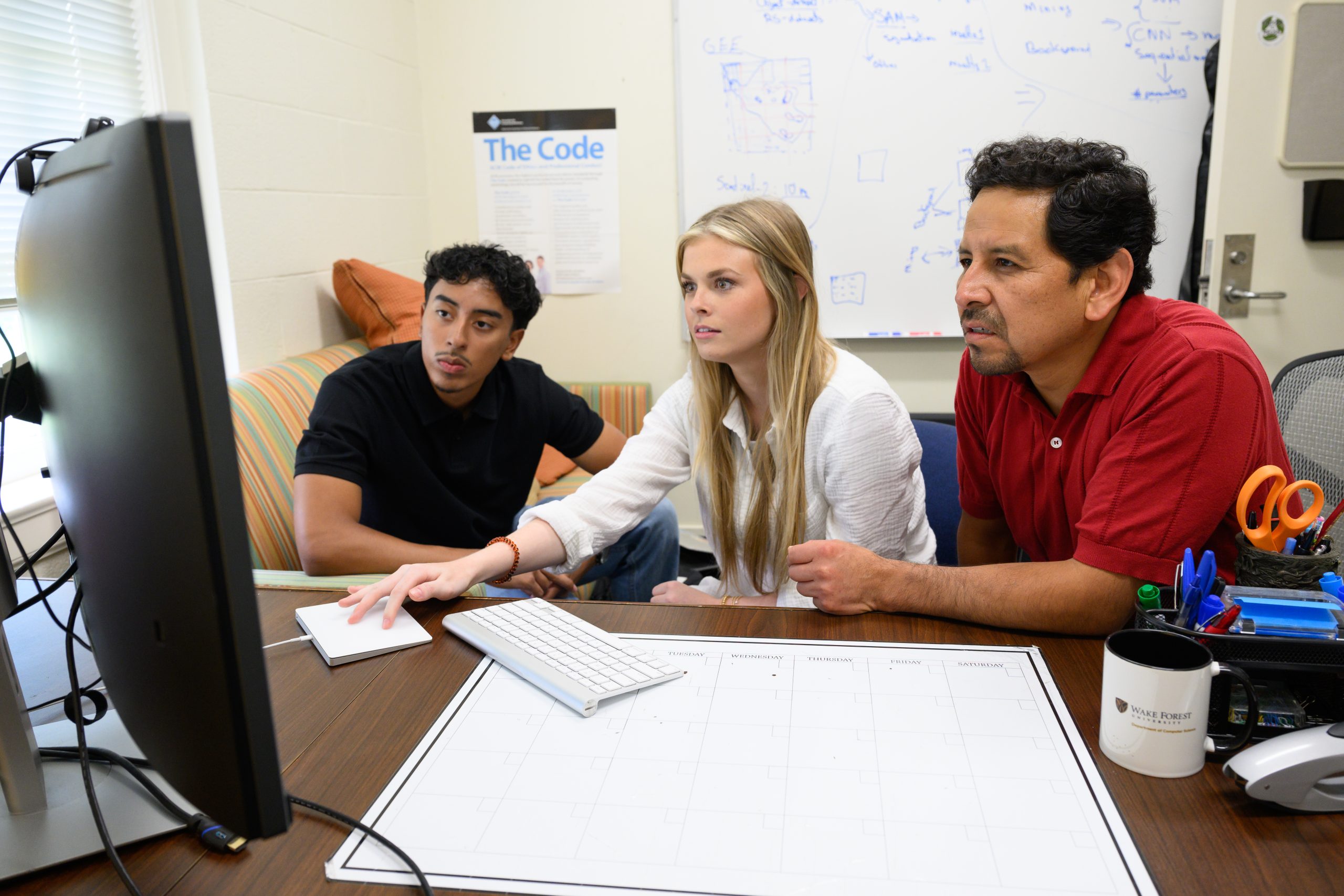 Wake Forest University URECA Scholars Mario Auqui (’25) and Malory Pitts (’26) work with Computer Science Prof. Paúl Pauca to build a model that can detect gold mining sites, especially illegal ones around the world using satellite images. Illegal mining often causes serious harm to local ecosystems, so being able to find and track these areas can be really important for environmental protection. The trio reviewed progress on the project in Prof. Pauca’s office in Manchester Hall on Wednesday, July 30, 2025.