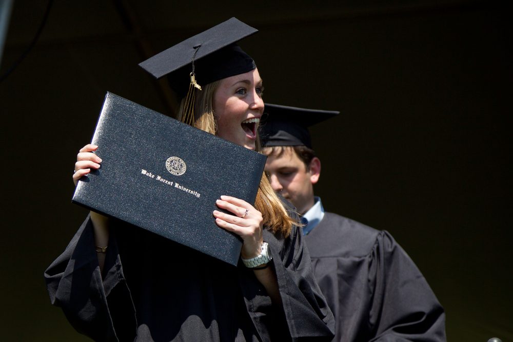 Students cross the stage to receive their diplomas.