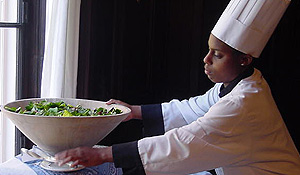 A student works as a buffet attendant.