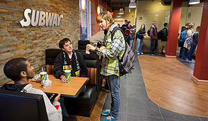 Students talk inside Subway.