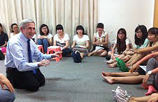 Sam Gladding with students in China