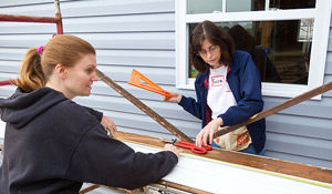 Roberta Powell, left, and Sara Blackburn of Financial Aid work on the 2010 house.