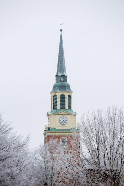 Ice-covered trees in front of the Wait Chapel spire and clock