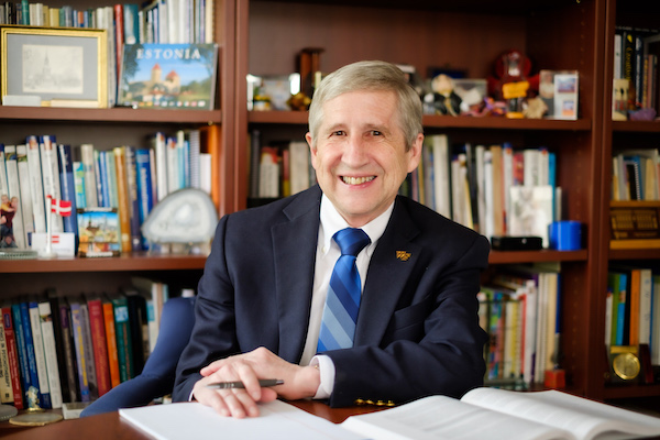Headshot of WFU professor of counseling Sam Gladding sitting at his desk in front of a bookshelf