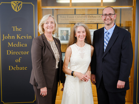 Photo of Wake Forest University President Susan R. Wente, Megan Medica and Jarrod Atchison posing in front of a sign that says "The John Kevin Medica Director of Debate"