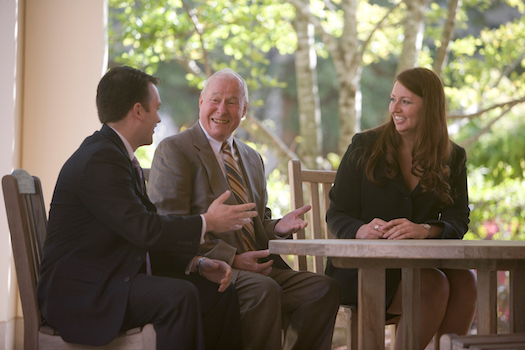 Photo of Professor Bern Beatty sitting at a table outside of Farrell Hall with Bern Beatty Scholars Lori Bremer (MBA '07) anad Karl Burns (MBA '08)