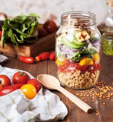 Photo of fresh tomatoes, lettuce, and a quinoa salad jar