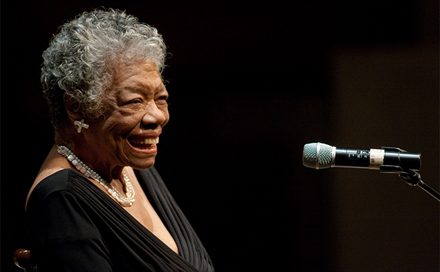 Photo of Dr. Maya Angelou smiling in front of a microphone