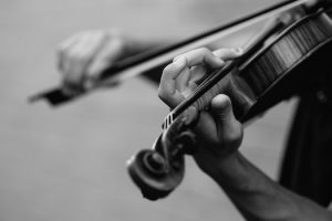 Black and white photo of a person playing a violin